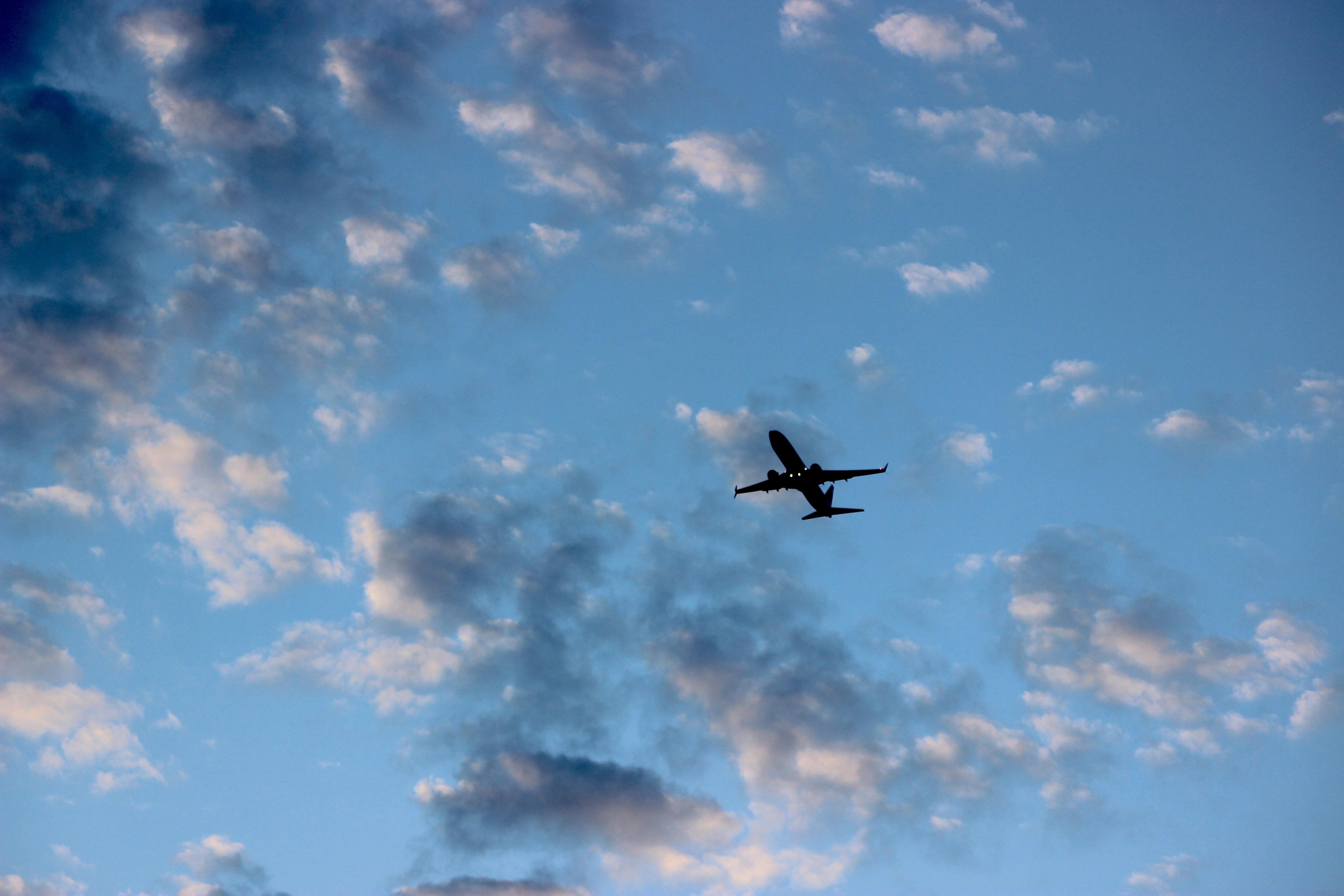 Airplane Against a Textured Sky 4K wallpaper
