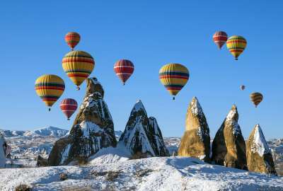 Balloons Over Snowy Cappadocia