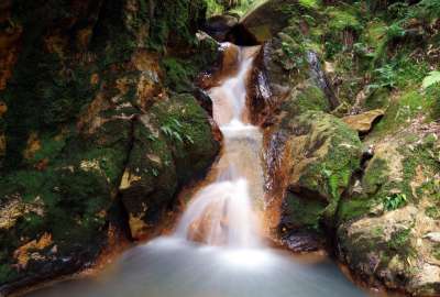 Waterfall Through Mossy Rocks