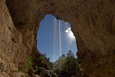 Natural Tunnel in Arizona With a Small Waterfall