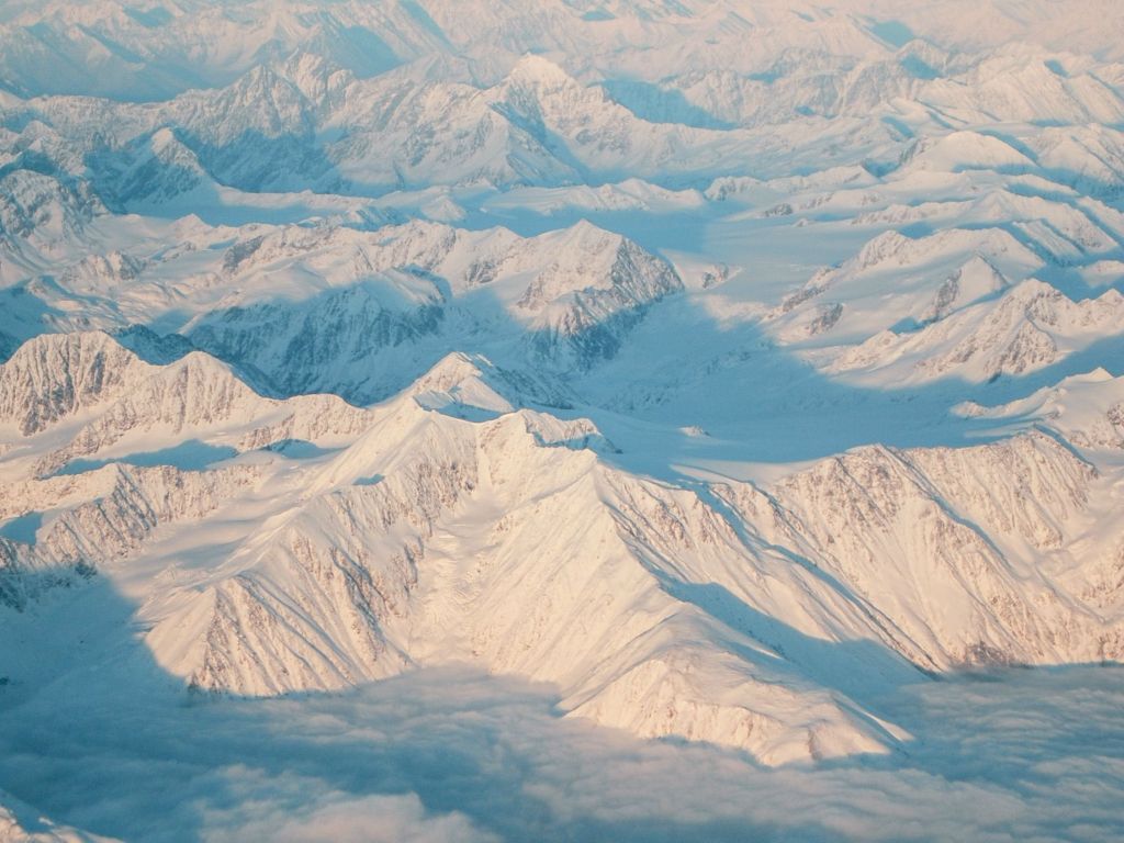 Alaskan Mountaintops Taken From Plane Seat Window wallpaper