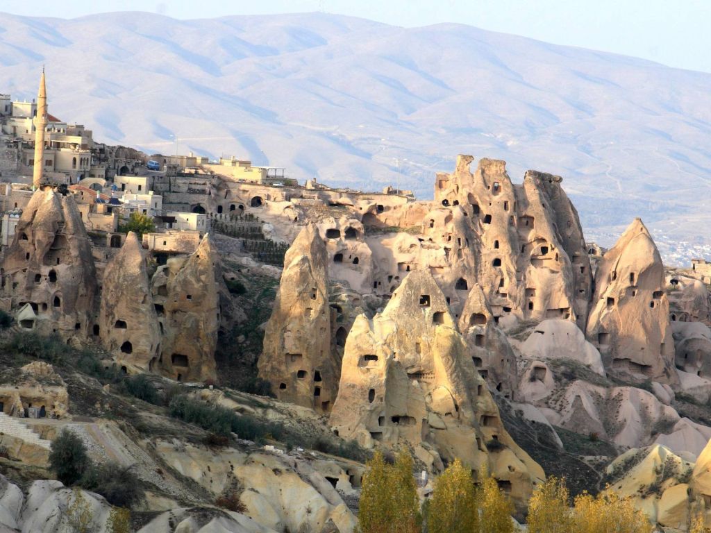 Ancient Rk Houses Intermingled With Modern Houses in Cappadia Turkey wallpaper