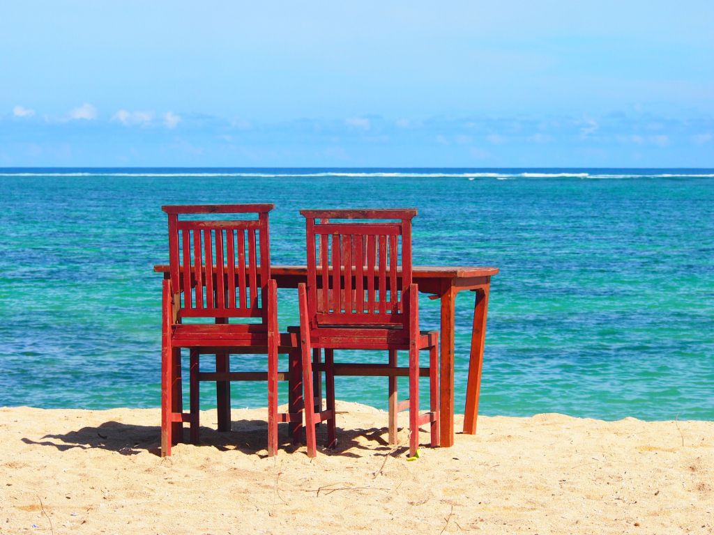 Chairs and Table on a Beach wallpaper
