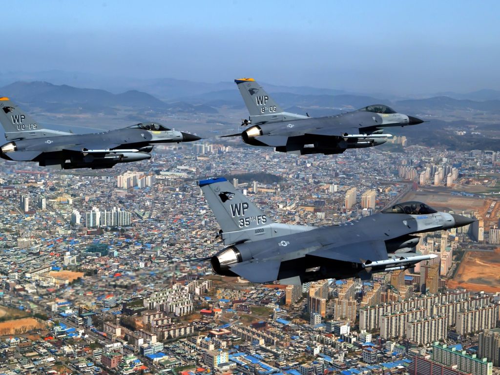 F Fighting Falcons Over City wallpaper