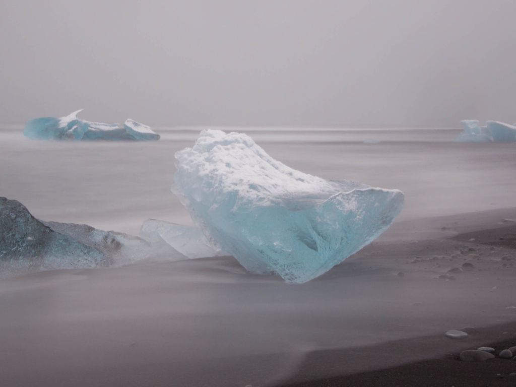 Iceland - Glacial Icebergs on a Black Volcanic Sand Beach and a Dusting of Snow Stujophoto wallpaper