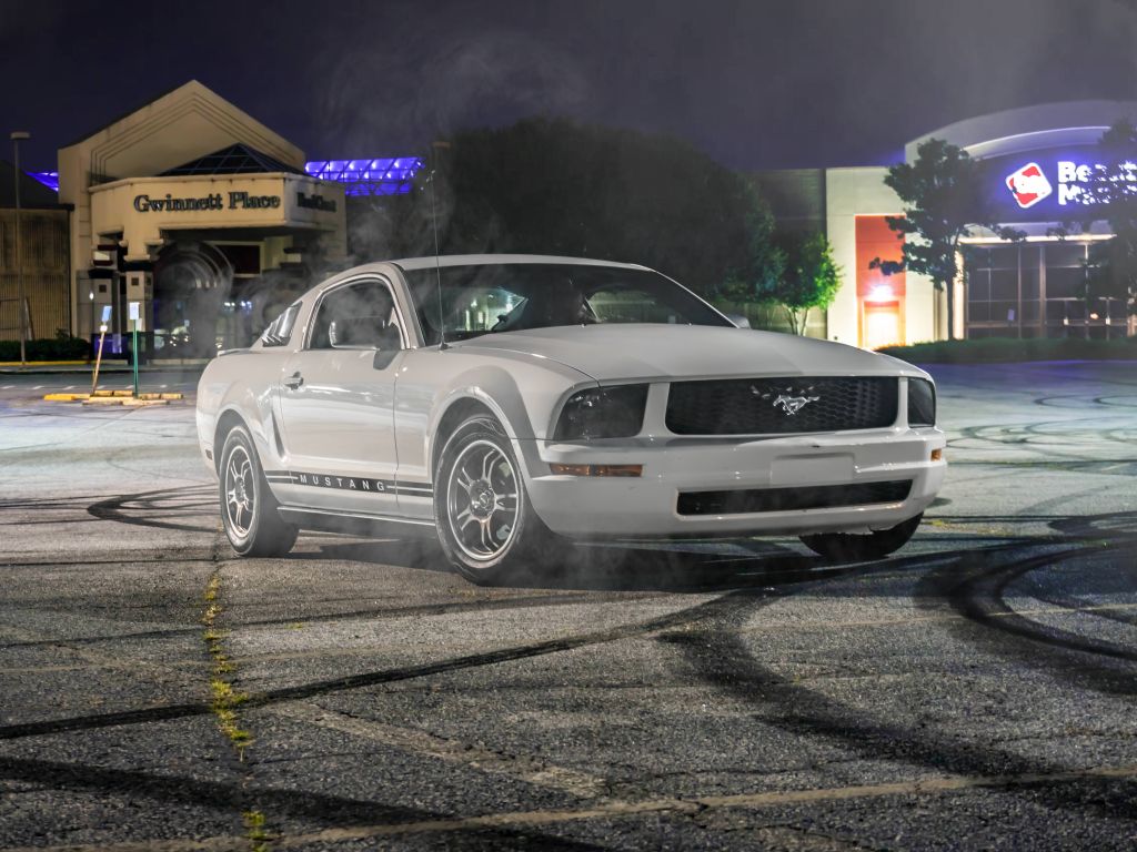 Mustang Sitting on Top of Burnt Rubber From Donuts wallpaper