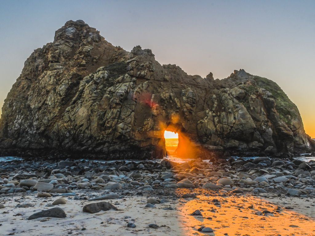 Sunlight Shining Through the Keyhole Rock in Big Sur California wallpaper